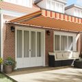 vidaXL Sklopná markíza Žltá a oranžová 600 × 350 cm Polyester a hliník