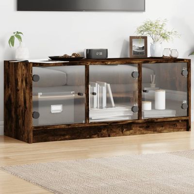 vidaXL TV skrinka so sklenenými dvierkami dymový dub 102x37x42 cm